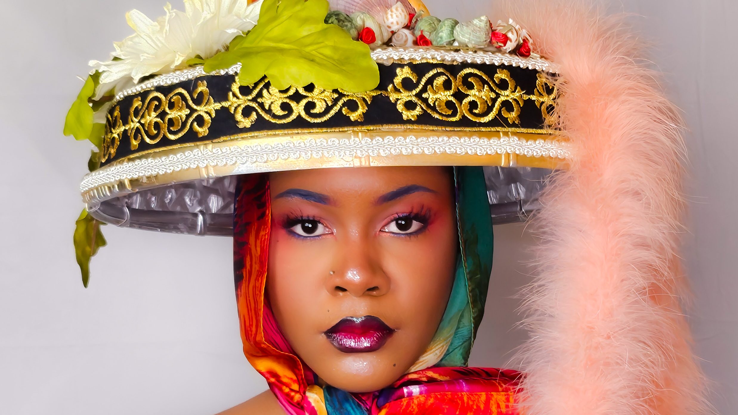 woman wearing decorative hat and scarf.